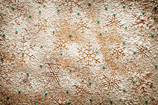 Christmas background with snowflakes for winter. Snowflake pattern made of icing sugar on wooden table. Top view