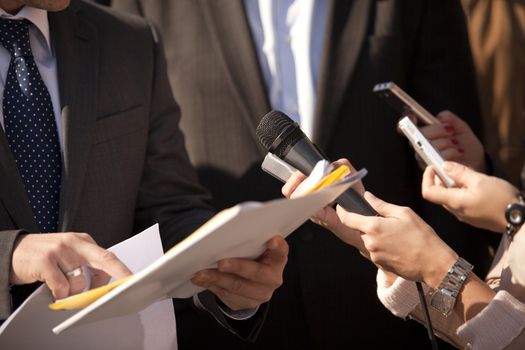 A journalist is making a interview with a microphone