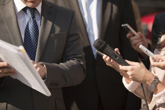 A journalist is making a interview with a microphone