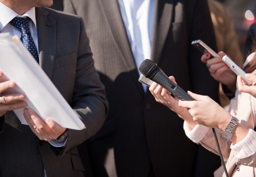 A journalist is making a interview with a microphone