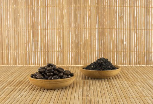 coffee beans and  tea leaves on bamboo table