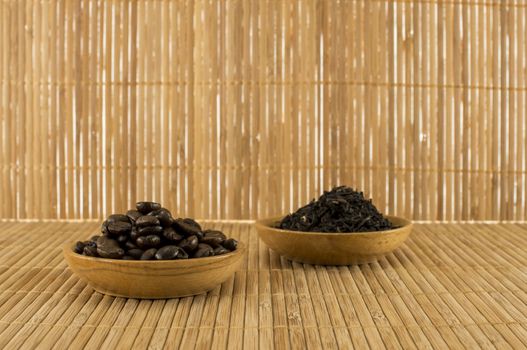 coffee beans and  tea leaves on bamboo table