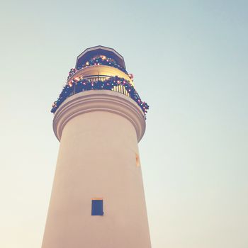 Lighthouse with christmas ornaments, retro filter effect 