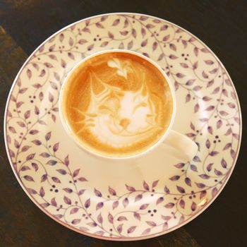 Cute latte art coffee with cat face, retro filter effect