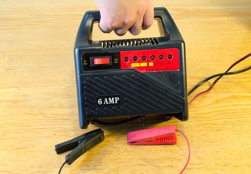 Hand hold car automobile battery accumulator 6V 12V 6AMP charger. Simple tool used at home.