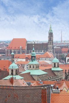 View over Nuremberg old town from the Kaiserburg, Franconia, Bavaria, Germany, with the spires of the Town Hall or Rathaus and St Lawrence church or Lorenzkirche.