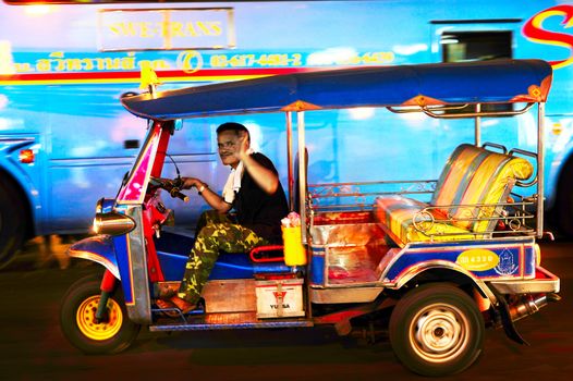 Bangkok, Thailand - March 03, 2013: Tuk - tuk on Chinatown street at night in Bangkok. There are more than 100,000 "tuk-tuk" in Bangkok