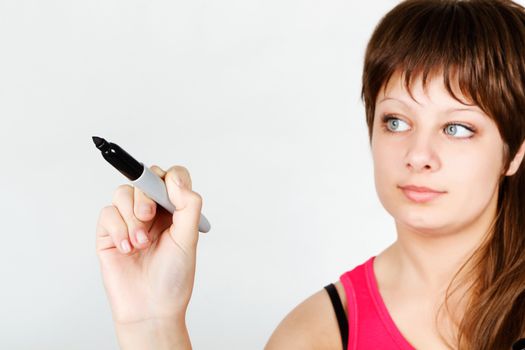 Young attractive girl writing in black marker