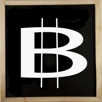 A blackboard with the white symbol of bitcoins