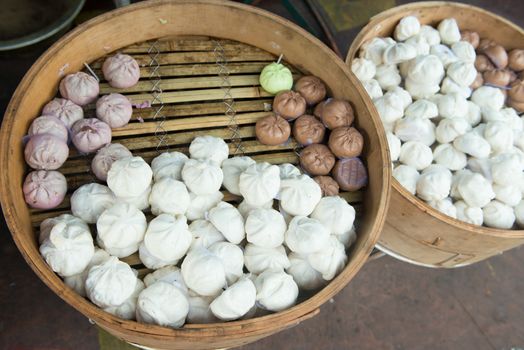 Chinese steamed buns in traditional bamboo steamer