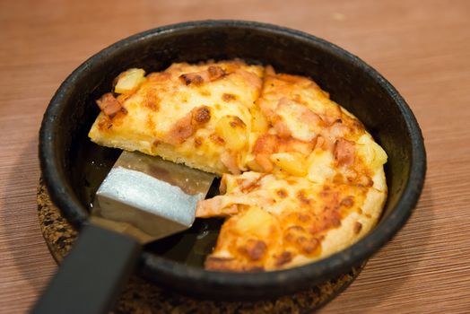 Chicken pineapple pizza in hot pan ready for serve