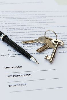 Real estate contract with pen and keys