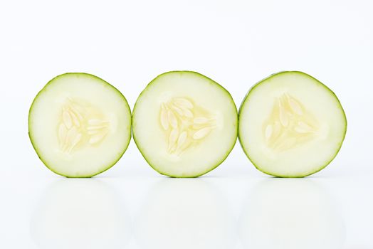 Three cucumber slices isolated on white background