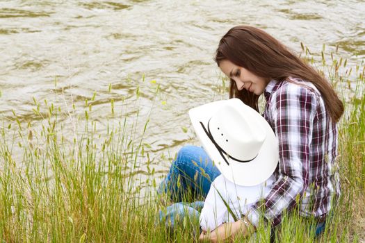 Mother and toddler son sitting by the riverside