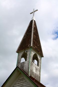 Bell tower and cross on old church building