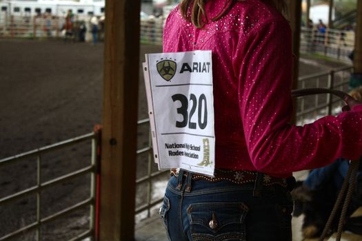 MERRITT; B.C. CANADA - MAY 15: Unidentified cowgirl with a number on her back resting inbetween rounds at the Nicola Valley Rodeo on May 15; 2011 in Merritt; British Columbia; Canada