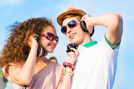 young couple standing on the road, having fun with friends