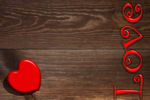 The red heart and the inscription on the wooden background, a Valentines Day theme.