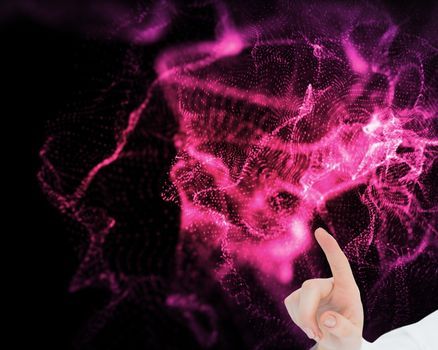 Composite image of model pointing at something on black background glowing pink