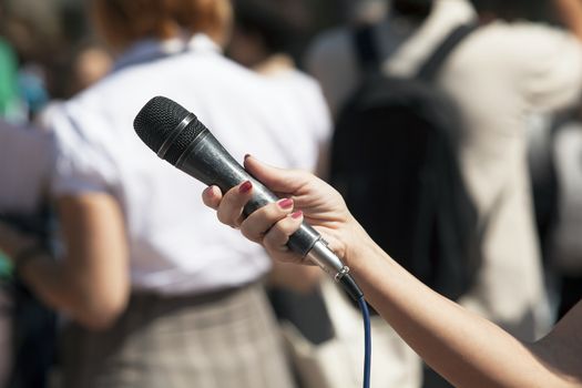 A journalist is making a interview with a microphone