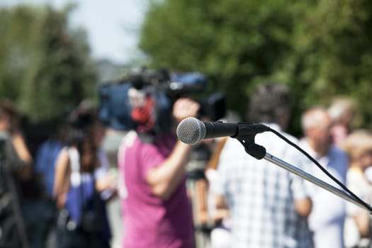 A microphone on a stage in front of audience