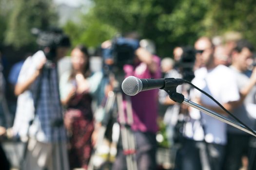 A microphone on a stage in front of audience