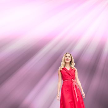 Composite image of cheerful blonde woman looking at camera on pink shiny background