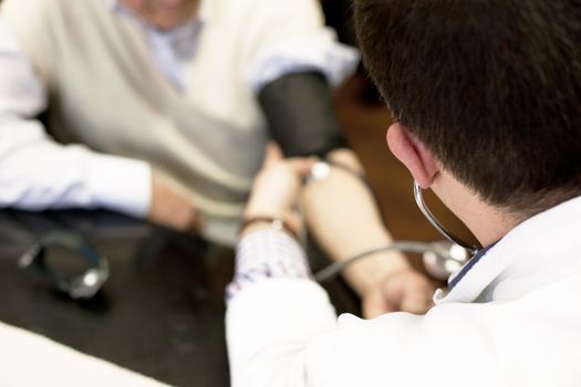 Doctor/nurse checking senior men blood pressure