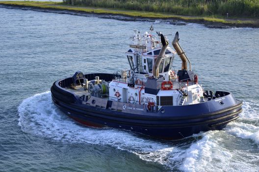tug boat used to guide and position ships as they enter the panama canal locks on its way to escort another ship through transit.







tug boat,utility boat,panama canal,panama,transport,water,locks,gatun,
