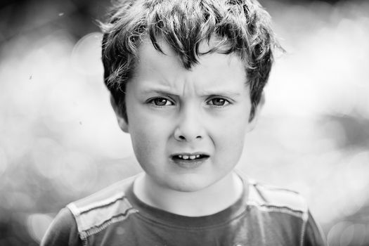 Boy annoyed with the flies around his head