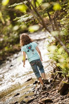 Girl playing near the river