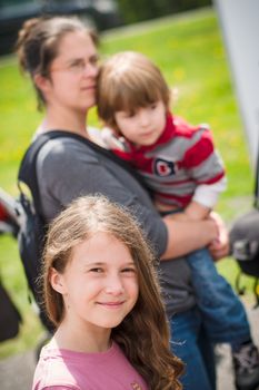 Girl standing near her family and waiting in line