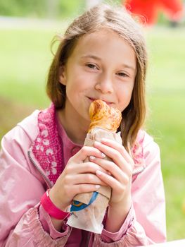 Girl eating freshly baked bread rolls