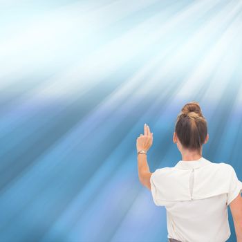 Composite image of businesswoman pointing at something with two fingers on shiny blue background