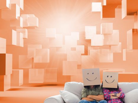Composite image of silly employees with arms folded wearing boxes on their heads in orange room with 3d cubes