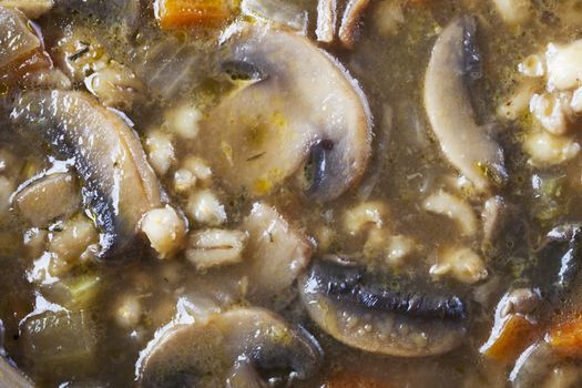 Mushroom and barley soup close up background.