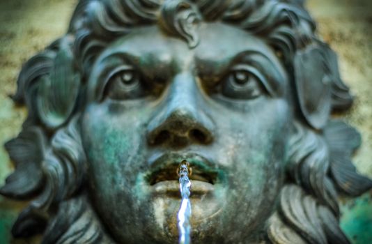 Ornamental Water Fountain With Face And Water In Focus