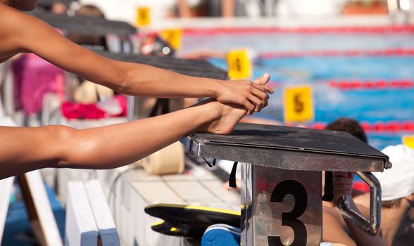 Swimmer warming up and stretching legs