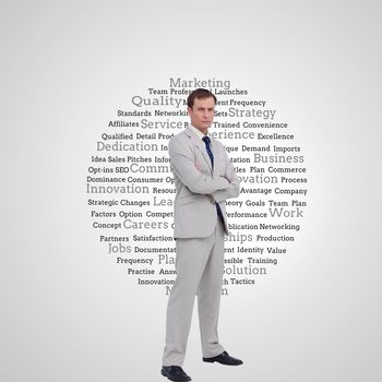 Composite image of serious businessman standing with his arms folded 