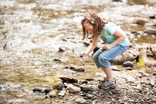 Girl playing near the river