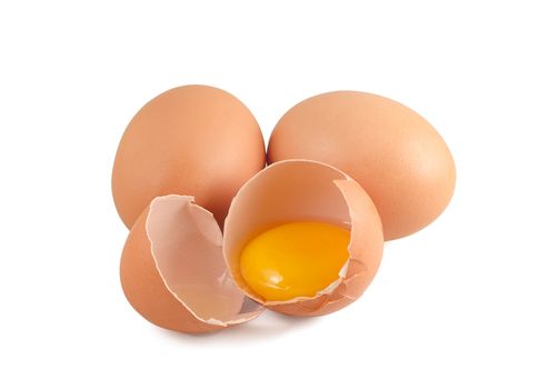 Three raw eggs one of them cracked isolated on white with clipping path