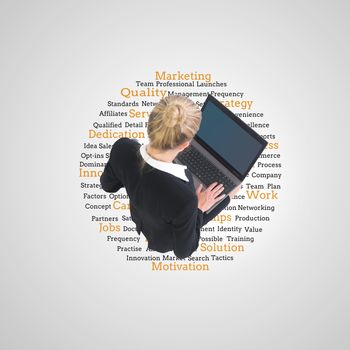 Composite image of blonde businesswoman using laptop