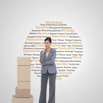 Composite image of thoughtful businesswoman posing with cardboard boxes