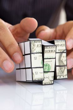 business man hand holding a rubik's cube,money concept