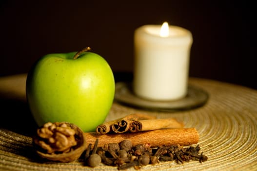 Green apple, cinnamon, walnut and a candle