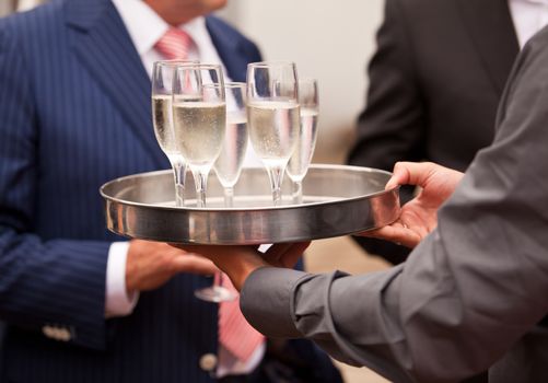 Waiter serving champagne at a party