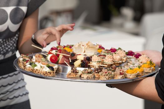 Waiter carrying plates of food