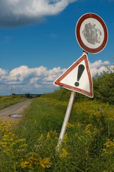 Old traffic signs on a narrow rural road