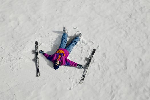 Female skier laying on the snow