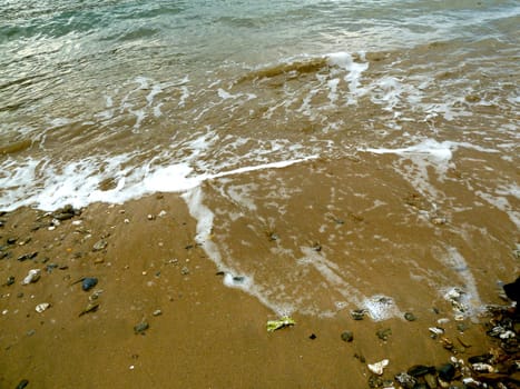 Gentle tidal surf on a sandy beach